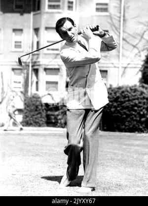 Takes Up The Other Fellow's Game Fred Perry, Tennis Champion of the World, Plays Golf whenever he has a spare moment between tennis tournaments. Perry has been offered a large sum to turn pro, but as yet has made no decision. He only recently won the pacific southwest tennis championship for the third successive time.He is shown here playing golf in California. July 19, 1934. (Photo by Associated Press Photo). Stock Photo