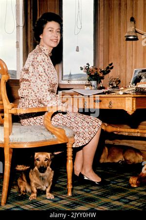 File photo dated 1/9/1972 of Queen Elizabeth II sitting in her study at Balmoral with a dog under her chair. During her reign, the Queen owned more than 30 corgis, with many of them direct descendants from Susan, who was given to her as an 18th birthday present by her parents in 1944 and was so loved that she accompanied Princess Elizabeth on her honeymoon. Issue date: Thursday September 8, 2022. Stock Photo