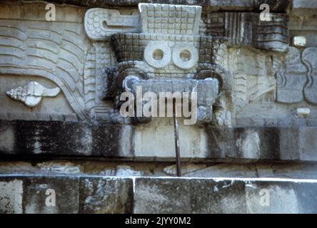 Mask of Tlaloc part of a sculpted frieze at the Temple of the Feathered Serpent, pyramid, Teotihuacan, a pre-Columbian site in central Mexico. The pyramid takes its name from representations of the Mesoamerican 'feathered serpent' deity which covered its sides. The structure is also known as the Temple of Quetzalcoatl, and the Feathered Serpent Pyramid. the structure, are dated to between 150 and 200 CE. Tlaloc was a member of the pantheon of gods in Aztec religion. Stock Photo