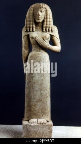 limestone Cretan sculpture called the Lady of Auxerre, (or Kore of Auxerre). Depicts an archaic Greek goddess of c. 650 - 625 BC. It is a Kore (maiden), perhaps a votary rather than the maiden Goddess Persephone. The Archaic sculpture, bearing traces of polychrome decoration, dates from the 7th century BCE, when Greece was emerging from its Dark Age. She still has the narrow waist of a Minoan-Mycenaean goddess, and her stiff hair suggests Egyptian influence. Stock Photo