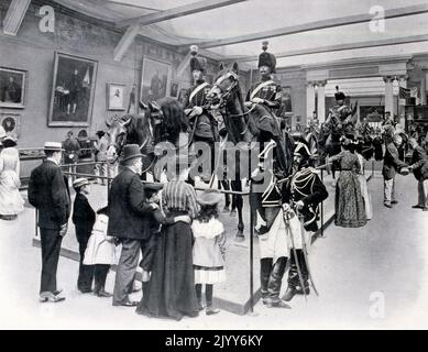 Black and white photograph in the Museum of the History of the Army, showing an exhibition under the Second Empire; at the back there is 'the little hat of Napoleon I', and in the glass cabinets are collections belonging to the Emperor. Stock Photo