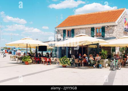 Murter Croatia - 31 July 2022: Cafe on the waterfront in center of Murter. Stock Photo