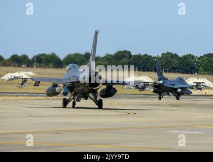 Two U.S. Air Force F-16C Fighting Falcons, assigned to the 555th Fighter Squadron from the 31st Fighter Wing, Aviano Air Base, Italy, taxi to the runway to begin familiarization training of the UK in preparation for the Royal Air Force’s Cobra Warrior 2022 exercise at RAF Lakenheath, United Kingdom, Aug. 30, 2022,. The partnerships created through recurring training events, like Cobra Warrior, better support NATO’s ability to employ a strategic force in theater whenever called upon.  (U.S. Air Force photo by Tech. Sgt Miquel Jordan) Stock Photo