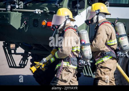 U.S. Marines with Aircraft Rescue and Fire Fighting, Headquarters and Headquarters Squadron, Marine Corps Air Station Miramar, spray water on flames coming from a mobile burn unit during an aircraft mishap full scale exercise on MCAS Miramar, San Diego, California, Aug. 17, 2022. This emergency response exercise was conducted for first responders in order to maintain proficiency and preparedness for potential real-world threats and hazards on the installation. (U.S. Marine Corps photo by Lance Cpl. Jose S. GuerreroDeLeon) Stock Photo