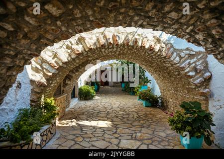 Courtyard of the Theotokos Monastery also known as Paleokastritsa Monastery, Corfu, Greece. Theotokos Monastery, Paleokastritsa town. Monastery of Vir Stock Photo