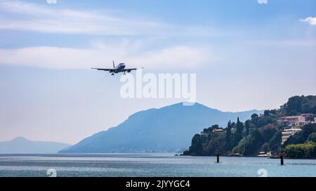 Landing airplane. Landscape with passenger airplane is flying in the blue sky with clouds. Passenger airliner. Business trip. Commercial aircraft. Pas Stock Photo