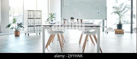 Empty boardroom, conference or meeting room with table, chairs and whiteboard. Business presentation office, corporate company interior space and Stock Photo