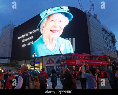 The large screen in Piccadilly Circus in London displaying a spectacular image of Queen Elizabeth II immediately following her death Stock Photo