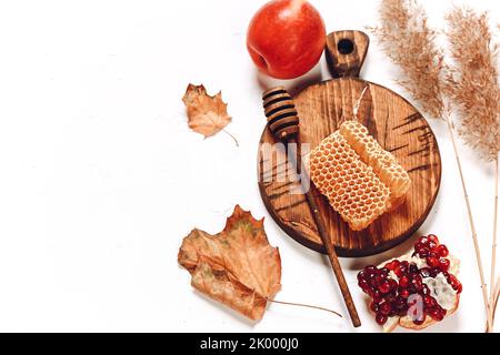 Pomegranate apples and honey. Autumn composition. Traditional Jewish holiday New Year. Happy Rosh Hashanah. Stock Photo