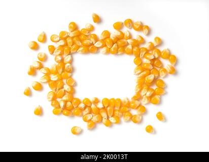 Square copy space made of dried corn kernels on white background. Corn for popcorn. View from above. Stock Photo