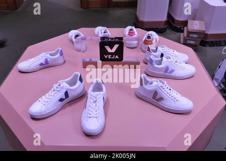 VEJA SHOES ON DISPLAY INSIDE A FASHION STORE Stock Photo