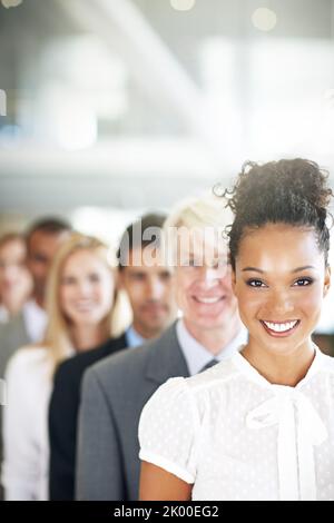 Making their mark on the business world. a group of diverse businesspeople standing in a line. Stock Photo