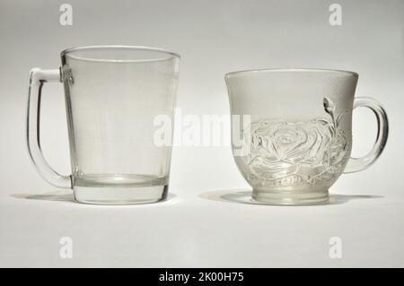 Empty cups, Two used glasses on white background, Transparent glass Stock Photo