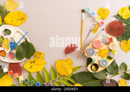 Children's picture made from autumn leaves with pencil drawing on paper Stock Photo