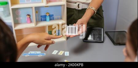 Unrecognizable teacher explaining to her students the parts of a ...