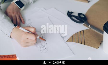 Close-up of designer drawing a fashion sketch Stock Photo - Alamy