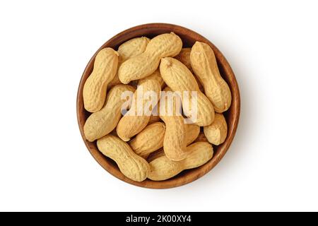 Shelled peanuts in wooden bowl on white background Stock Photo