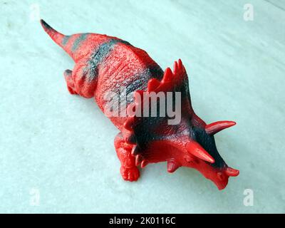 Tyrannosaurus dinosaurs toy isolated on stone  background with clipping path Stock Photo