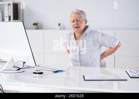 Woman With Back Pain. Bad Office Posture Stock Photo