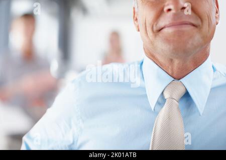 Imposing figure - Leadership. Cropped image of a senior businessman smiling and wearing a tie. Stock Photo