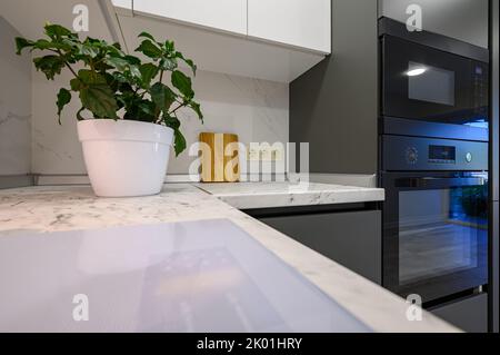 Marble worktop of modern white and dark grey kitchen Stock Photo - Alamy
