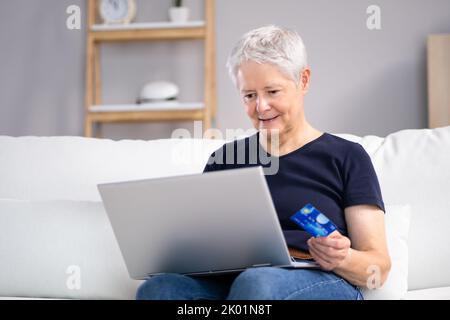 Online Shopping Using Card Credit On Laptop Stock Photo