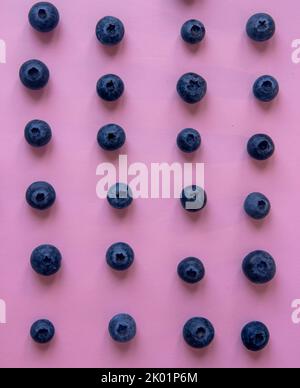 Blueberries isolated on pink background, a close-up of a pattern of blueberries Stock Photo