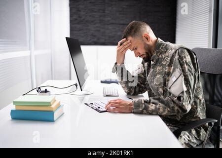 Sad Frustrated Military Veteran Student Doing Test In College Stock Photo