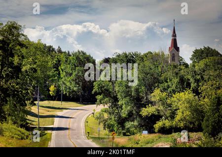 A winding road leads to a church that stands in the countryside near Manitowoc, Wisconsin. Stock Photo
