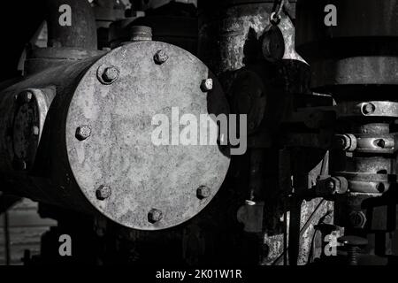 An old steam engine, sits out near a street while being warmed by the sun in Two Rivers, Wisconsin. Stock Photo