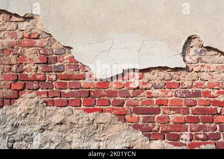 Old brick wall background with partly chipped cement plaster (copy space) Stock Photo