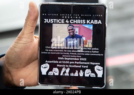 London, UK, 9th Sep 2022 London UK A Man shows protestters a digital flyer for a planed  demonstration for Chris Kaba whot was shot dead by police.  Chris Kaba, 24, was shot dead by an armed Met Police unit following a car chase in Streatham, south London. An investigation by the Independent Office for Police Conduct found out that he was not armed. Stock Photo