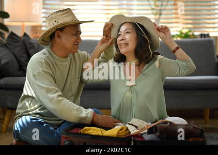 Excited retired couple getting ready for travel vacation after quarantine. Traveling in retirement concept Stock Photo