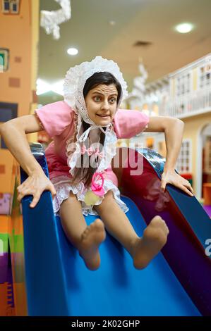 Happy funny woman newborn baby in daycare center Stock Photo