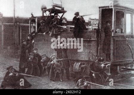 October days of 1917 in Moscow. Zamoskvorechye workers are fighting from an armoured tram platform. On November 3, 1917, an armed uprising in Moscow won. The establishment of Soviet power in Petrograd and in Moscow was crucial for the victory of the revolution throughout the country. Stock Photo