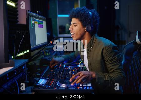 Radio host speaking into microphone Stock Photo