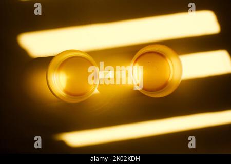 yellow plastic cup isolated on light and shadow Stock Photo