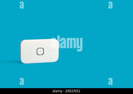 A compact modem device on a blue background with copy space Stock Photo