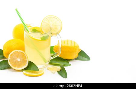 Lemon juice in a glass isolated on a white background with copy space,Lemon sliced with leaves. Stock Photo