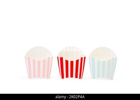 Striped colored boxes for fried potatoes on a white background with copy space Stock Photo