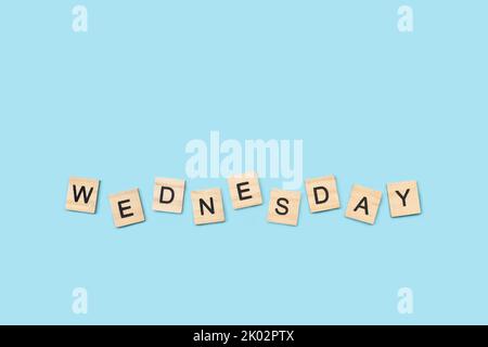 Wednesday write with wooden letter cubes on a light blue background Stock Photo