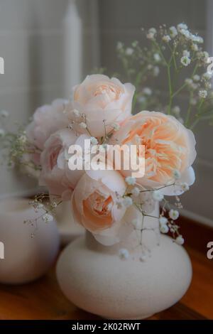 A vertical shot of orange English roses in a vase Stock Photo - Alamy