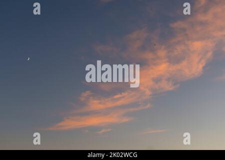Clouds, red, orange, sky, crescent moon, evening glow Stock Photo