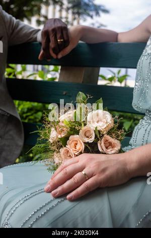 A vertical shot of a newly married couple holding hands Stock Photo