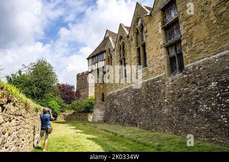 A woman taking photos of Stokesay Castle, Shropshire UK Stock Photo