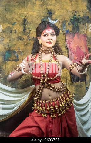 Concept Agomoni shoot with black haired Indian brunette  woman face with perfect makeup  and wearing jewelers with traditional dress like goddess . Stock Photo