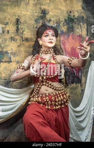 Concept Agomoni shoot with black haired Indian brunette  woman face with perfect makeup  and wearing jewelers with traditional dress like goddess . Stock Photo