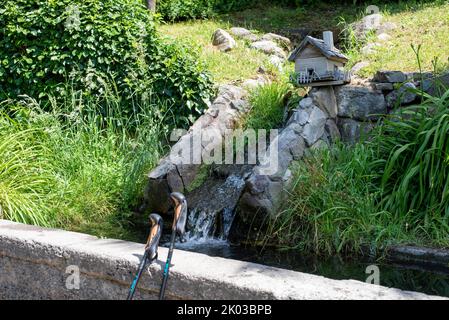 Miniature waterfall, walking sticks, spa town of Merano, South Tyrol, Italy Stock Photo