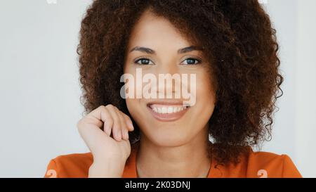 Pensive confused African American woman 20s curly haired smart girl pondering thinking creative plan thinks deep in thoughts comes up with ideas Stock Photo