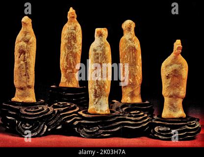 Tang Dynasty figurines of the twelve zodiac animals, each of which is an animal-headed person, wears a long robe, the trousers are long to the ground, the empty stomach, the hands are up to the chest, and the soil is red, and the whole body is covered with white powder, and many have fallen off. The animals are: rat, cow, tiger, rabbit, dragon, god, horse, sheep, monkey, chicken, dog, and pig. Stock Photo